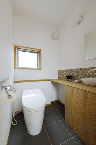 木目と白い壁のコントラストが美しいトイレ