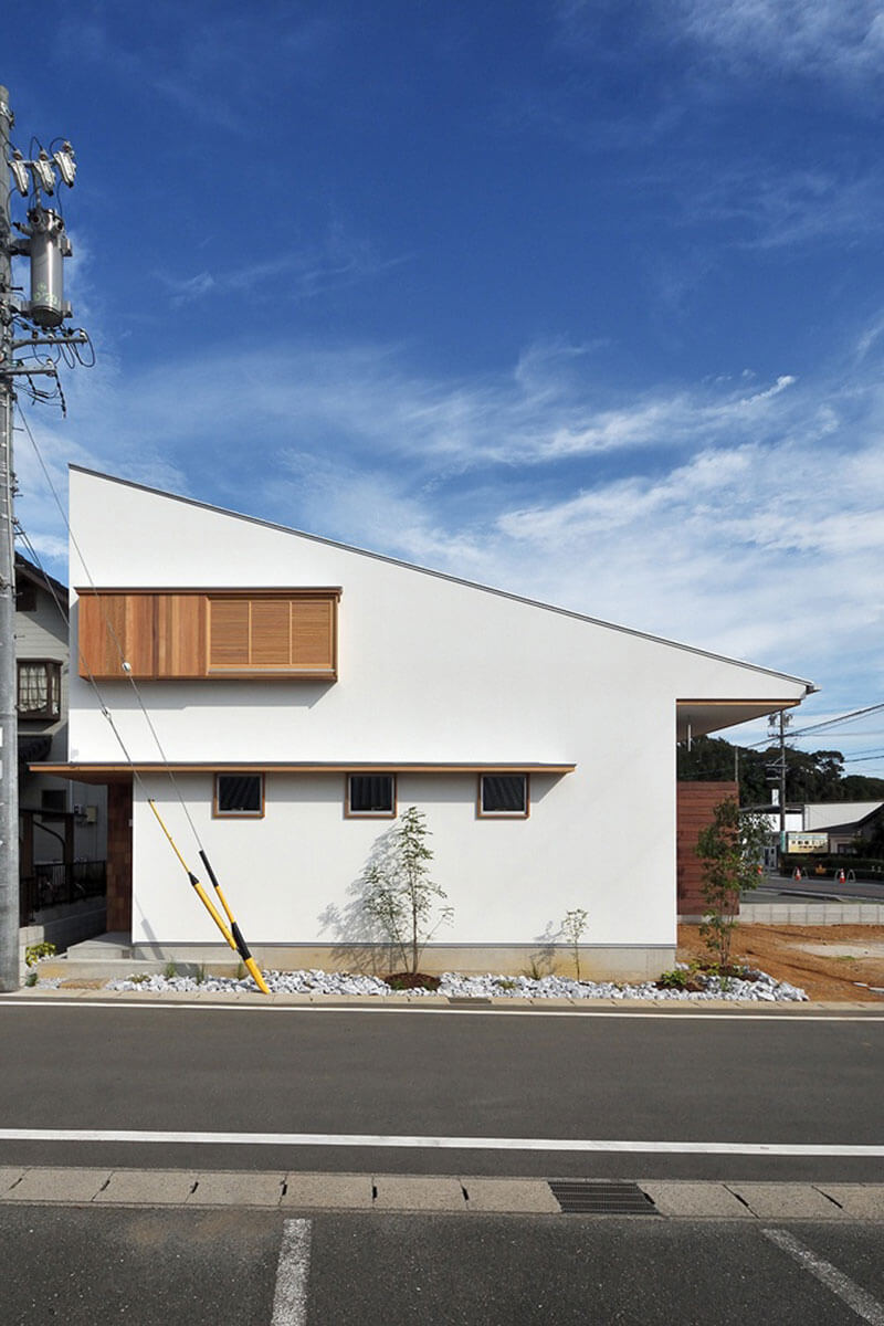 白の塗り壁の片流れ屋根の家