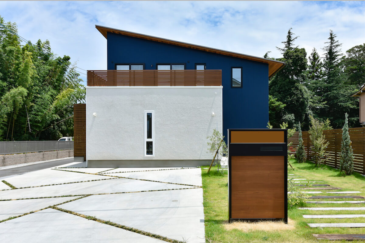 片流れ屋根と白いモルタル壁が爽やかな印象の家