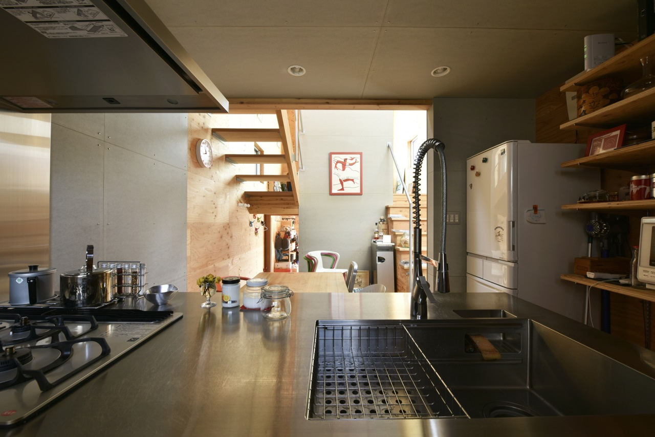 玄関の土間スペースから数段上がってダイニングキッチンへ